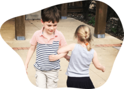 two kids dancing arm in arm